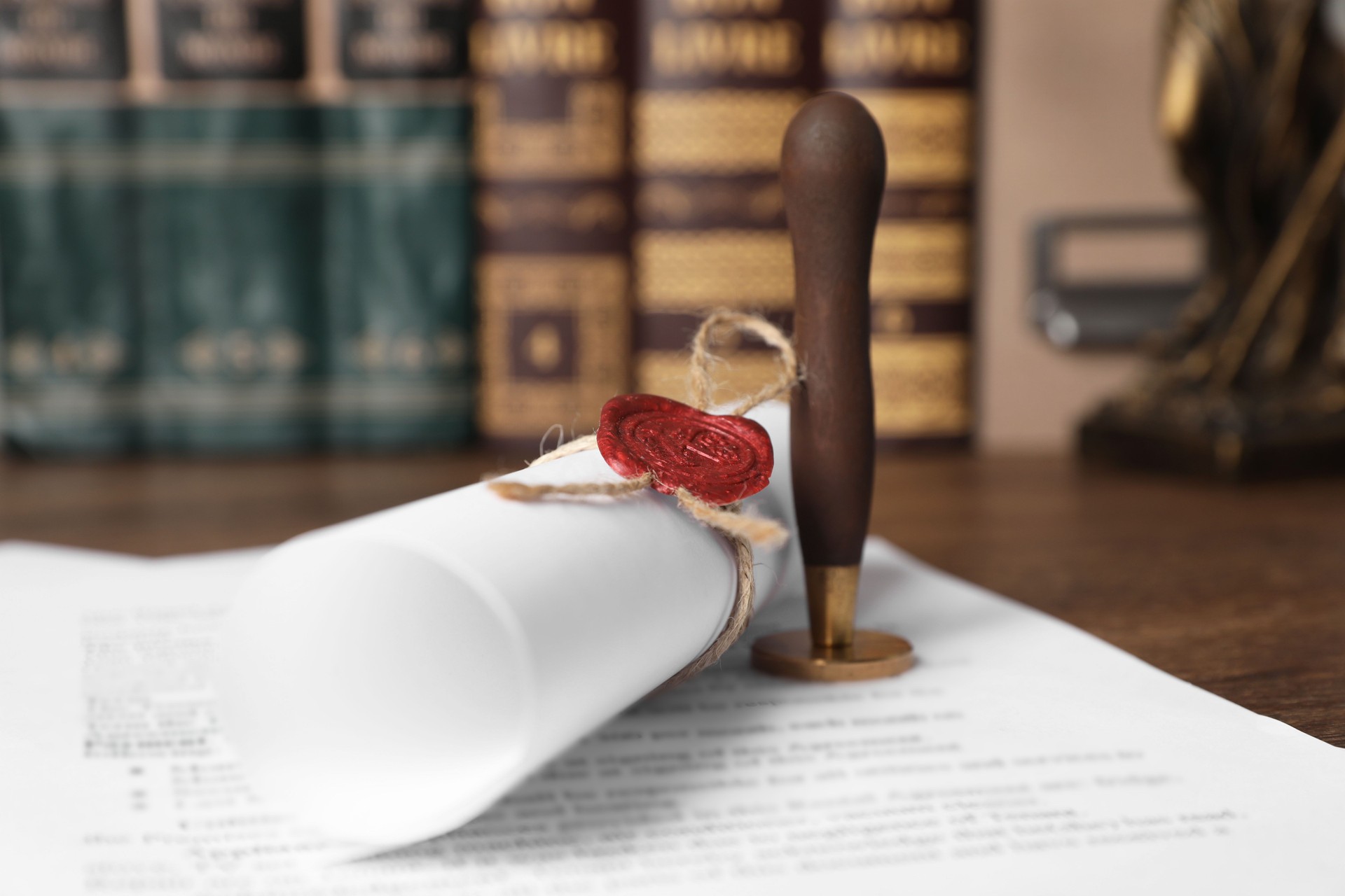 Documents and stamp on wooden table, closeup. Notary contract