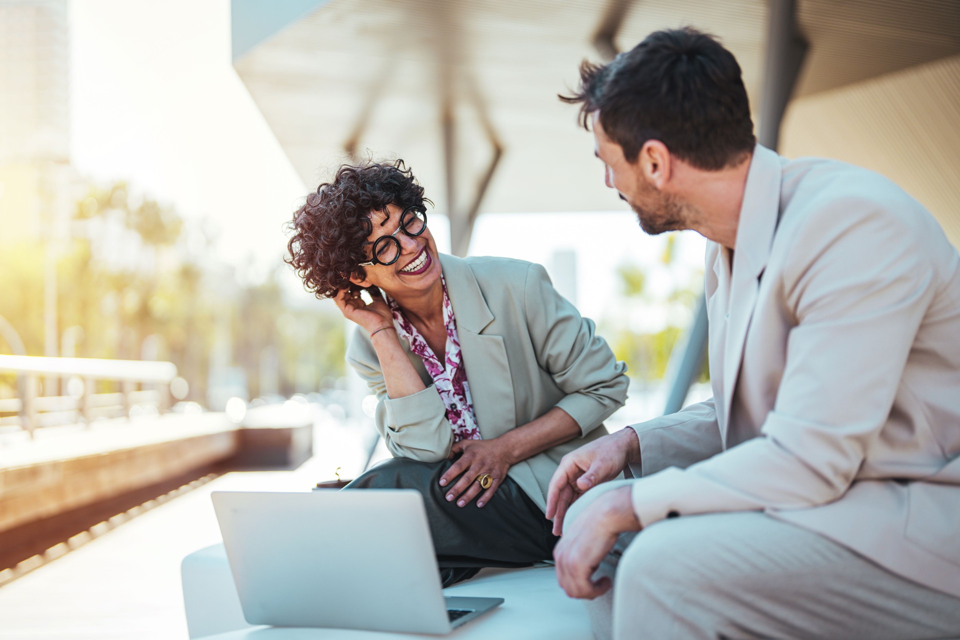 Collaborative Outdoor Business Meeting with Laptop